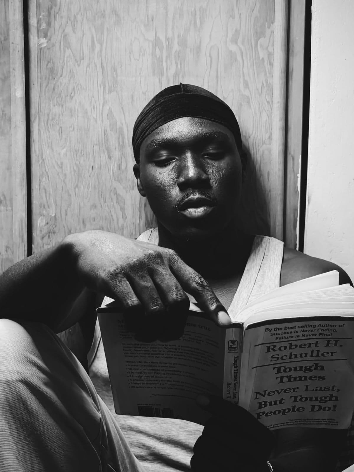 A young man reading a personal development book